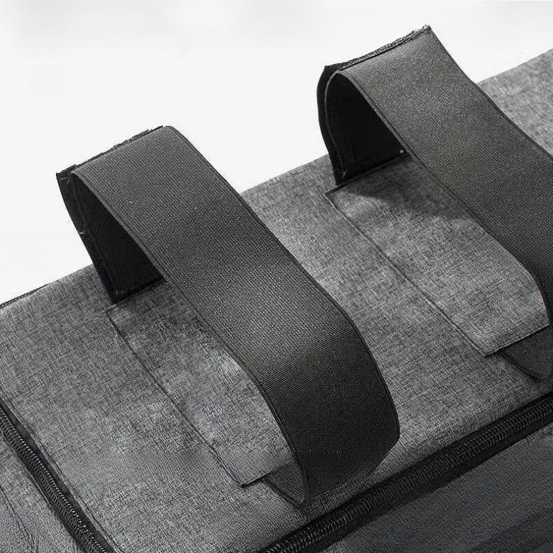 Close-up of a gray bag with black straps on a white background