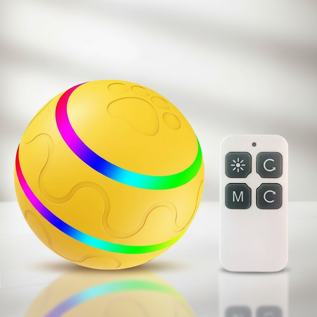 Yellow ball with colorful LED lights and a remote control on a reflective surface.