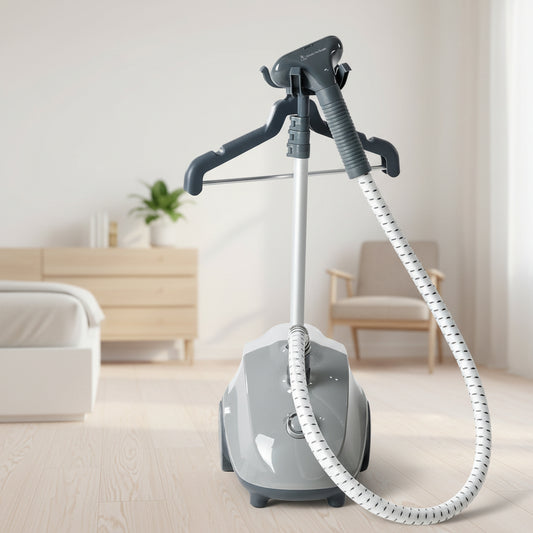 Gray garment steamer with hoses and attachments on a white background