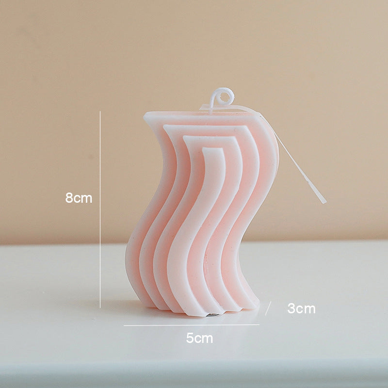 Pink silicone mold with measurements on a beige background